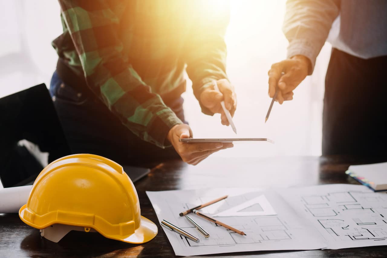 Construction and structure concept of Engineer or architect meeting for project working with partner and engineering tools on model building and blueprint in working site, contract for both companies.