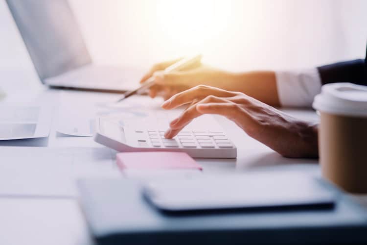 Financial analysts analyze business financial reports on a digital tablet planning investment project during a discussion at a meeting of corporate showing the results of their successful teamwork.